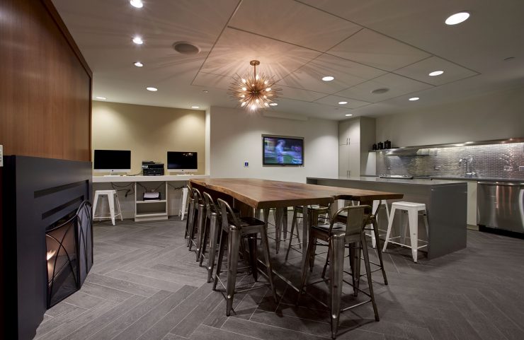 overview of the lounge, shared kitchen with high-top table and business center  