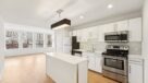 large open kitchen with white cabinets